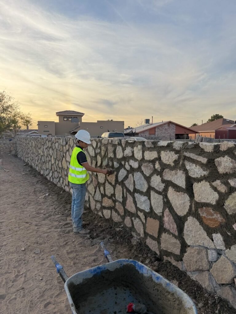 Contractor installing a rock wall in El Paso, Texas