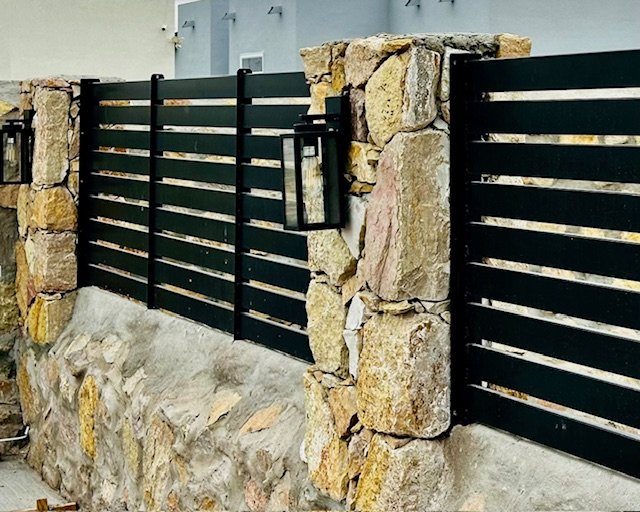 Rock wall columns and metal fence installation in El Paso, TX